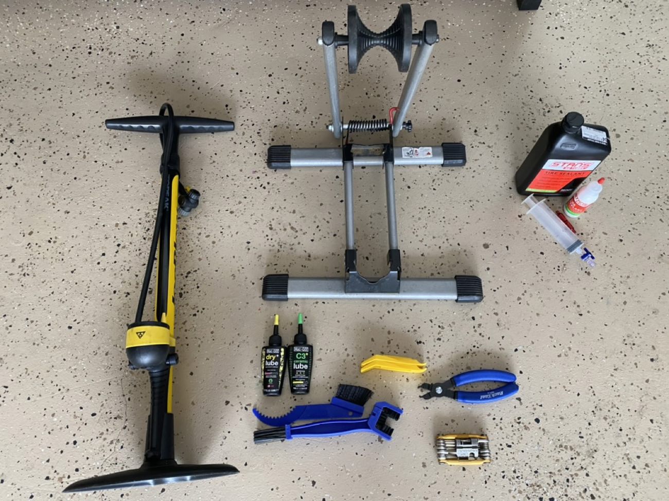Floor pump, wheel truing stand, chain lube, tire levers and a multitool laid out