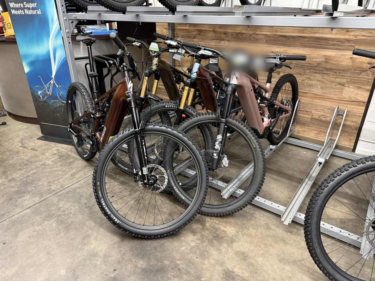 Row of electric mountain bikes lined up on a bike shop floor